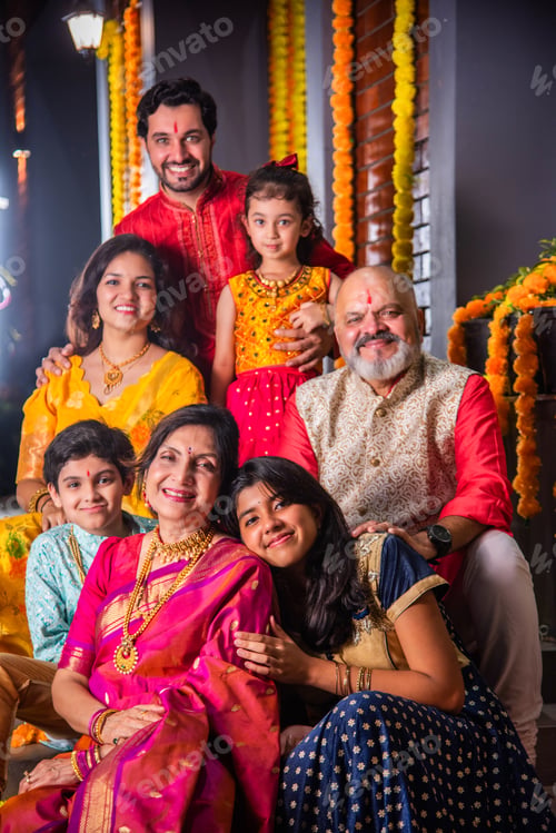Preview: Indian family in traditional attire taking a group selfie on steps in Diwali or festival celebration