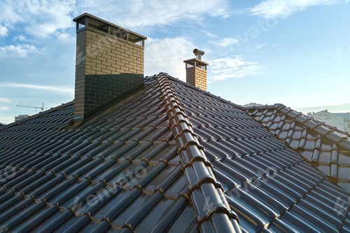 Preview: Closeup of house roof top covered with ceramic shingles. Tiled covering of building