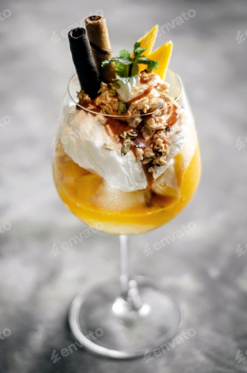 Preview: mango and passion fruit tropical ice cream sundae in glass