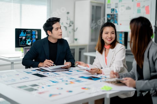 Preview: Marketing team analyzing diagrams and graphs during a meeting