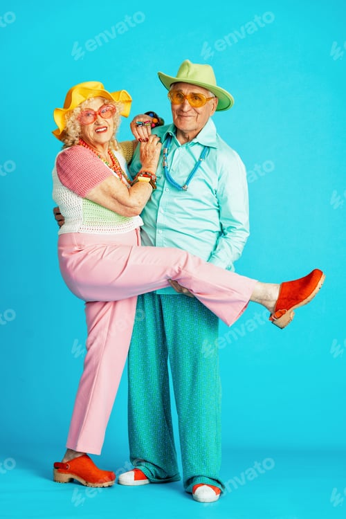 Preview: Beautiful senior old couple wearing fancy party clothes acting in studio on a colored background.