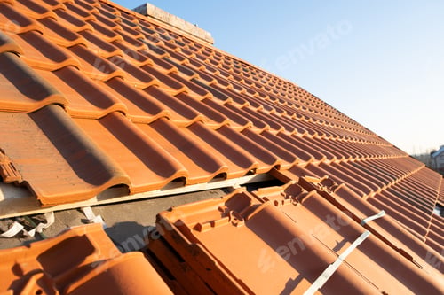 Preview: Overlapping rows of yellow ceramic roofing tiles mounted on wooden boards