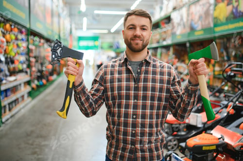 Preview: happy customer in a hardware store buying a new ax