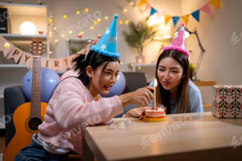 Preview: Two Asian women in room with Ciematic lighting celebrate important events such birthdays Christmas