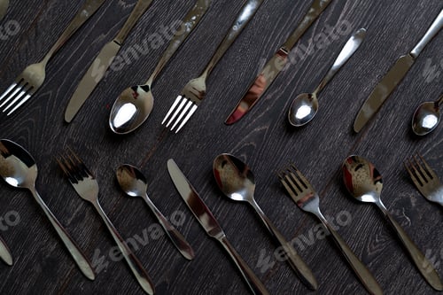 Preview: a classic set of steel cutlery flat lay on the colorful background pattern design