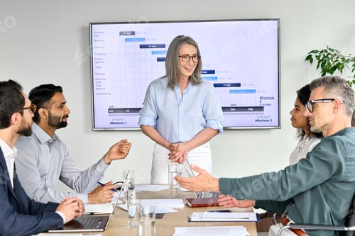 Preview: Happy diverse corporate team having presentation in boardroom office.