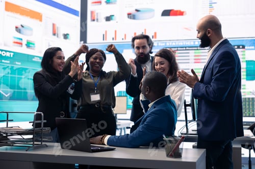 Preview: Business administrator celebrating expansion progress with his team