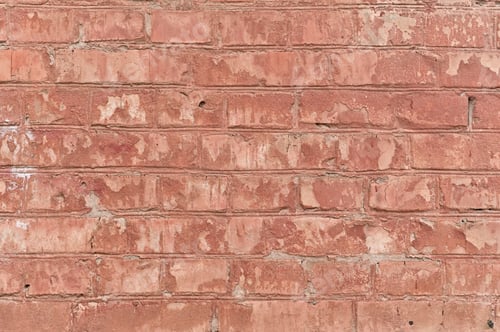 Preview: a shabby old wall with peeling red brick paint