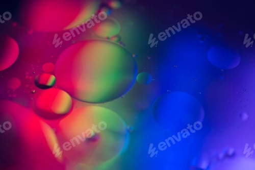 Preview: Macro shot of colorful oil and water circles illuminated