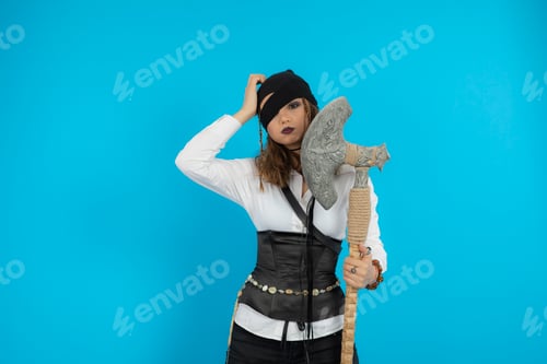 Preview: Pretty young pirate holding ax and put her hand to her head