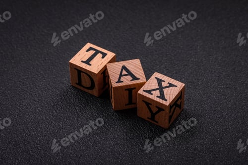 Preview: The inscription tax on wooden cubes on a dark concrete background