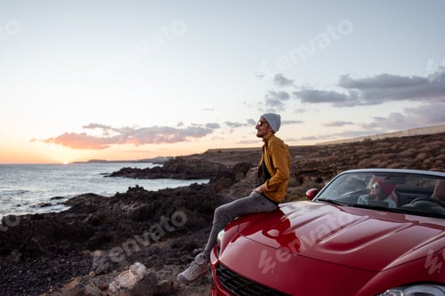 Preview: Lifestyle portrait of a man on the beach traveling by car