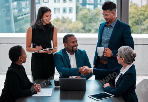 Preview: Were so happy to have you on board. Shot of coworkers shaking hands in a boardroom.
