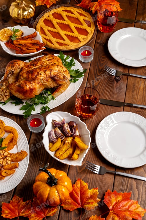 Preview: Thanksgiving Day table with turkey, pumpkin pie, roasted vegetables, top view.