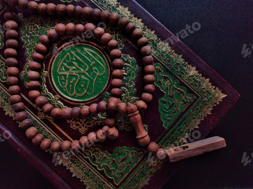 Preview: Holy Quran written arabic calligraphy meaning of Al Quran and Rosary beads