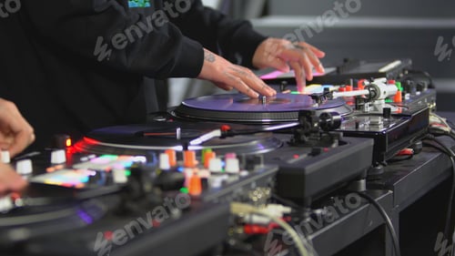 Preview: DJ spinning record at disco. Art. Close-up of DJ's hand on mixer. Glowing music panel at party