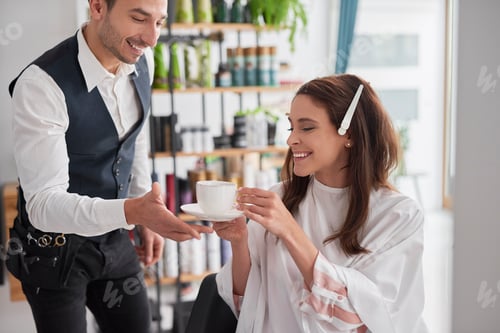 Preview: Woman in Salon Receives Drink From Stylist