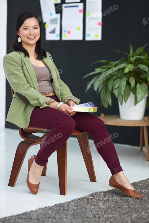 Preview: Stylish Woman Sits with Color Swatches in Office
