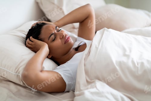 Preview: Chronic Migraine. Sick Young Black Woman Suffering Headache While Lying In Bed