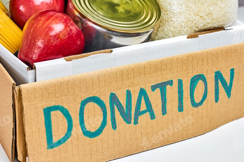 Preview: Close up a cardboard box with food for donation. Charity concept