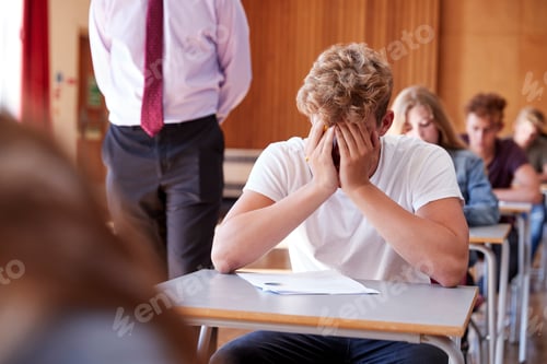 Preview: Anxious Teenage Student Sitting Examination In School Hall