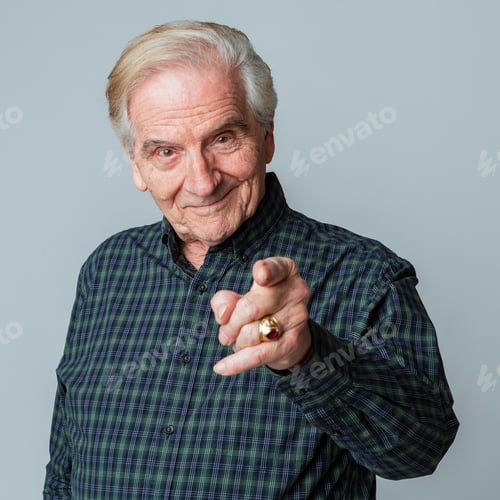 Senior Man Pointing Towards the Viewer Smiling