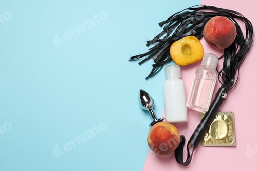 Preview: Lubricant with a whip, a peach and a condom on a blue-pink background, place for text