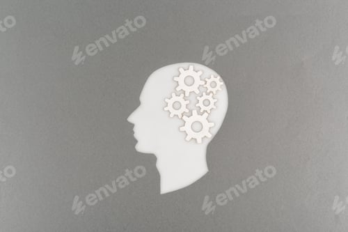 Preview: top view of cut out white human head with gears isolated on grey
