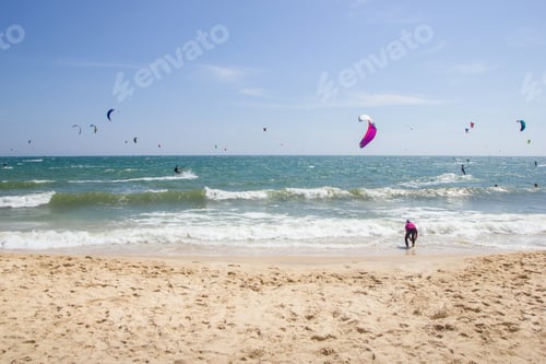 Preview: people on paragliders at beautiful sandy seashore, Vietnam, Mui Ne