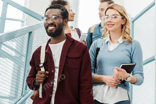 Preview: group of multiethnic students with backpacks in college