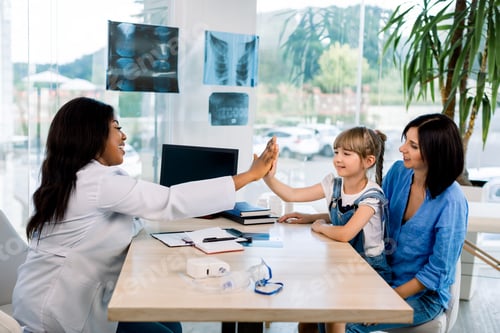 Preview: Happy child little girl give high five to african woman pediatrician welcome little patient and mom