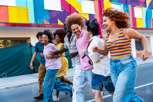 Preview: Multiethnic group of young friends meeting and having fun outdoors