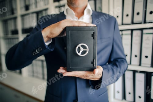 Preview: Businessman holding safe