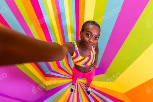 Preview: Beautiful young woman dancing and having fun inside a rainbow box room