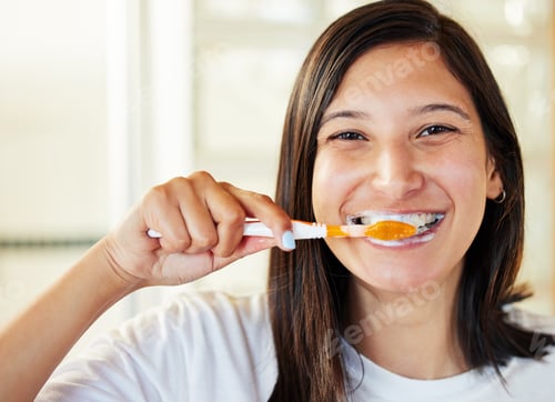 Preview: Closeup shot of a beautiful young woman brushing her teeth