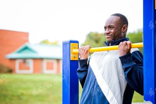 Preview: young man working out at outdoor gym