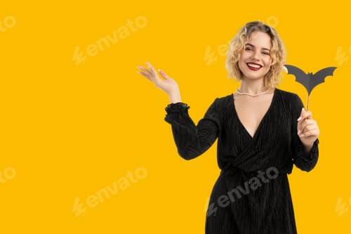 Preview: Woman in black dress joyfully celebrating Halloween