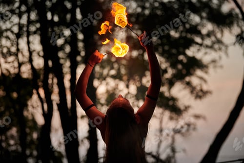 Preview: Girl fire dancing performance at outdoor art festival, smooth movements of female artist