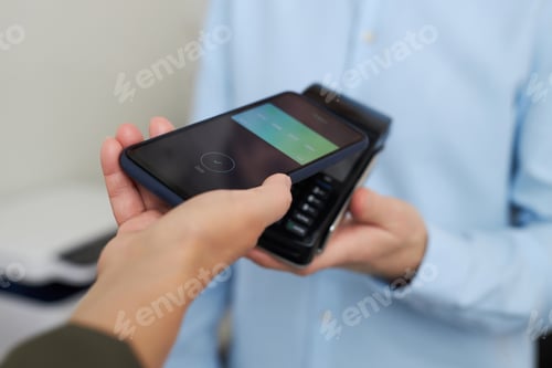 Preview: Closeup of unrecognizable woman paying via smartphone NFC