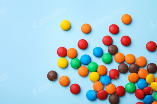 Preview: Tasty glazed candies and space for text on color background, top view