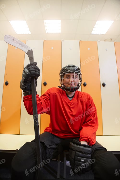 Preview: Female Hockey Player Posing in Locker Room