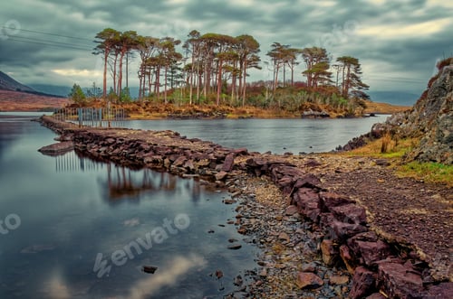 Preview: Dramatic morning cloudy lakeside landscape scenery at Derryclare Lough and Twelve pines island in At