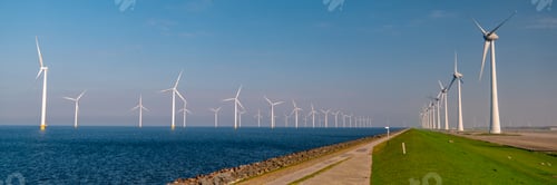 Preview: Windmill turbines at sea seen from a drone aerial view from above at a huge winmill park