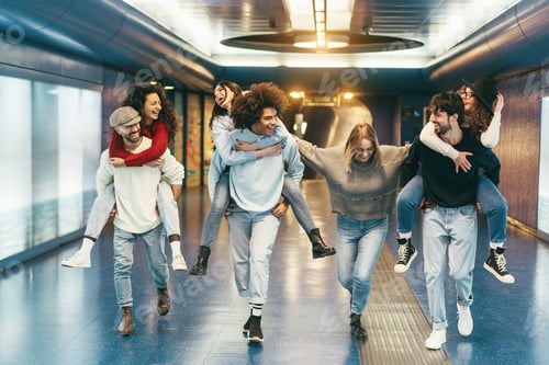 Preview: Happy friends having fun inside underground metropolitan station - Soft focus on center girl face