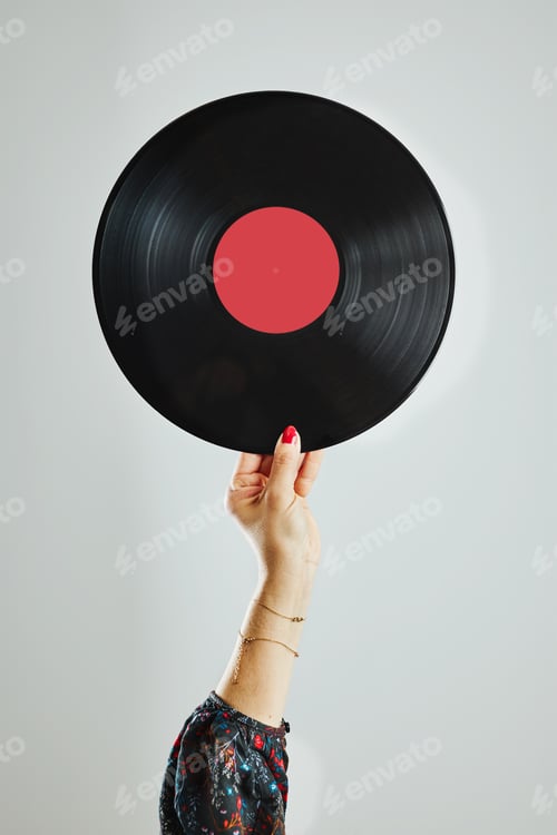 Preview: Woman holding vinyl record. Music passion. Listening to music from analog record. Retro music party