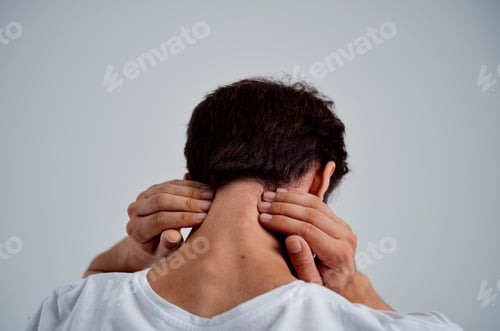 Preview: bearded man in a white t-shirt stress medicine pain in the neck light background