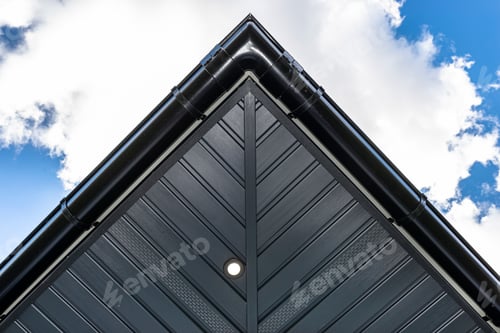 Preview: A modern graphite herringbone roof lining is attached to the trusses, visible turned on LED lights.