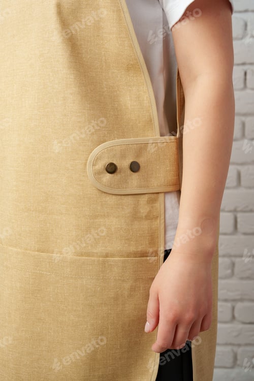 Preview: Close Up of Tan Canvas Apron With Metal Eyelet Detail