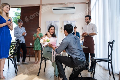 Preview: Asian romantic man making surprise proposal of marriage to girlfriend.