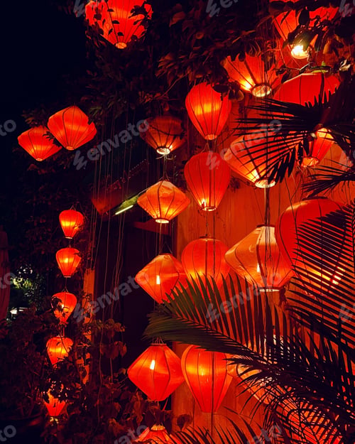 Preview: Vertical shot of beautiful illuminated orange paper lanterns in the evening